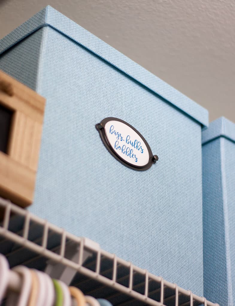blue textured box on closet shelf with label and metal handle