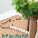 easy stenciled cork table mat runner with candlestick and wood beads and wooden stool with green wreath