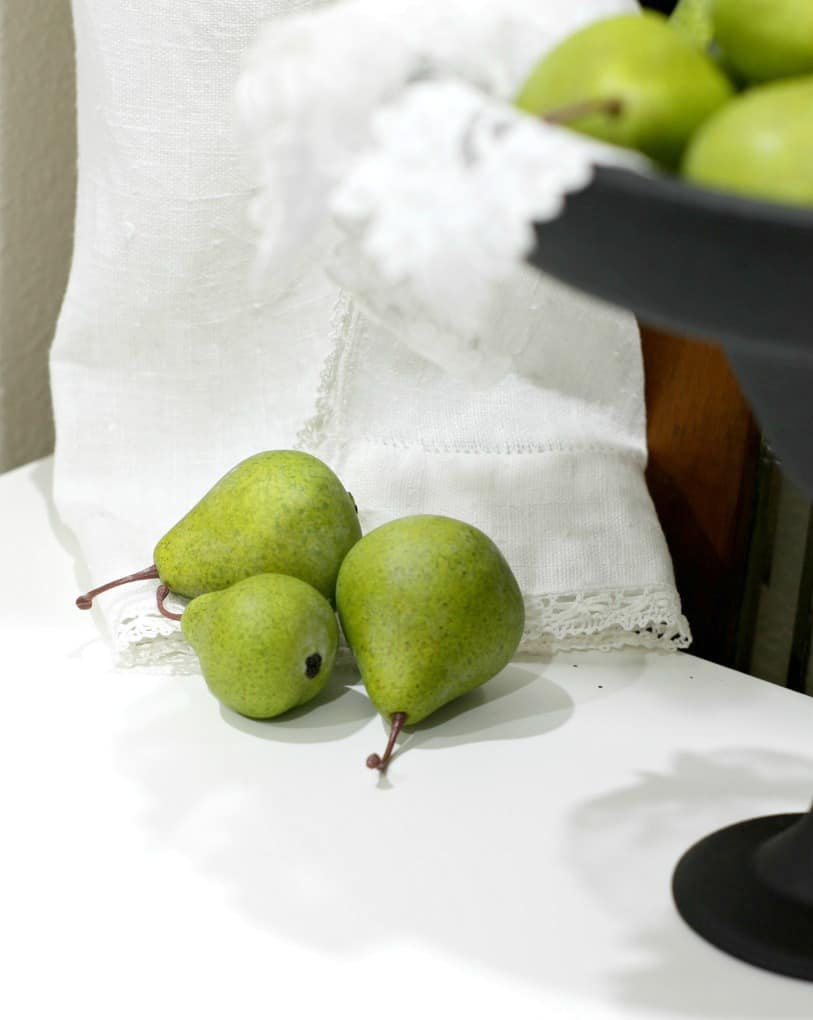 pears reasting on linen apron with cake plate on the side