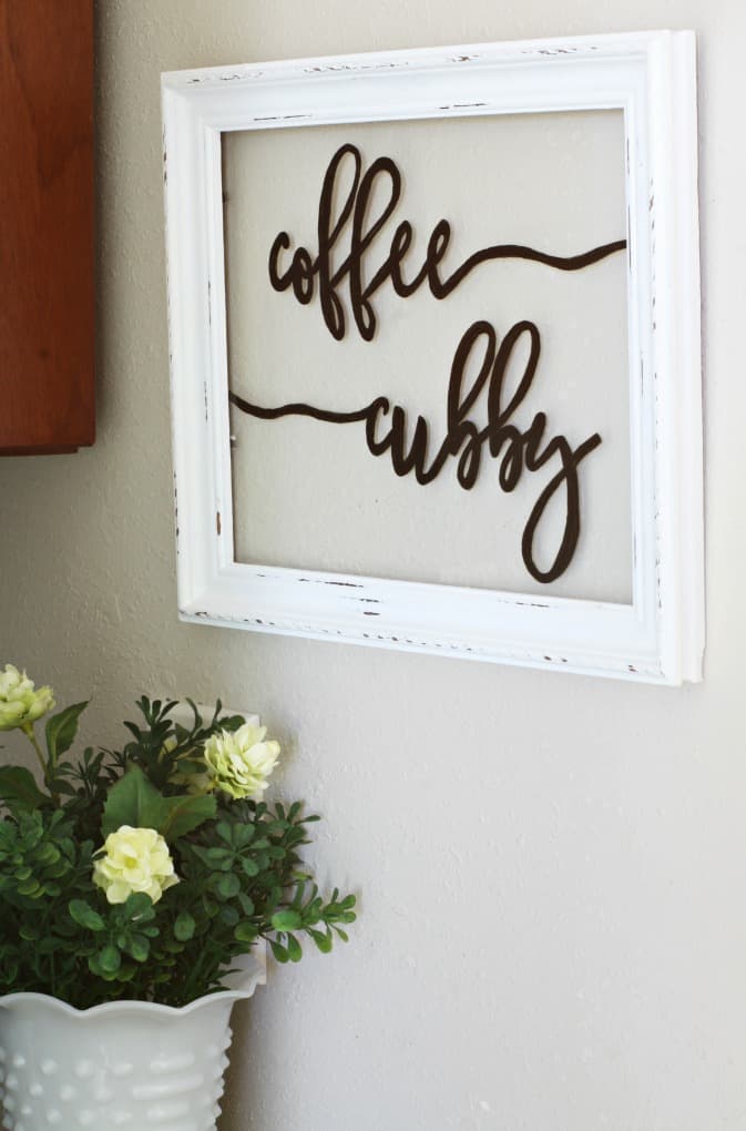 coffee cubby framed sign on wall with flower vase sitting on counter