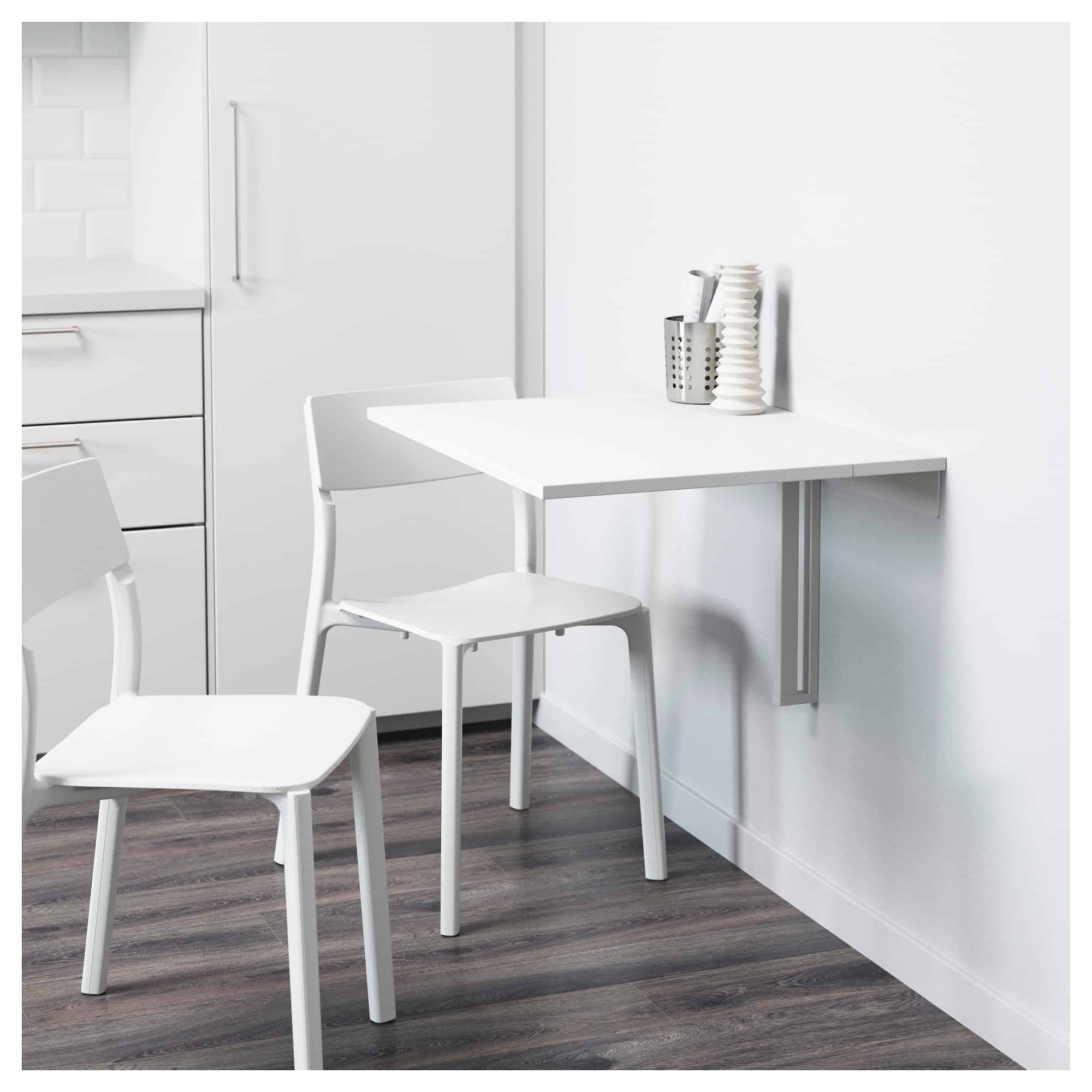 white drop leaf table with two chairs and decor in a white room