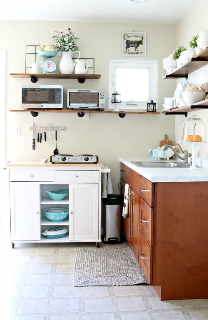 adding fall decor to a small kitchen small kitchen with cupboards open shelving portable island and decor items