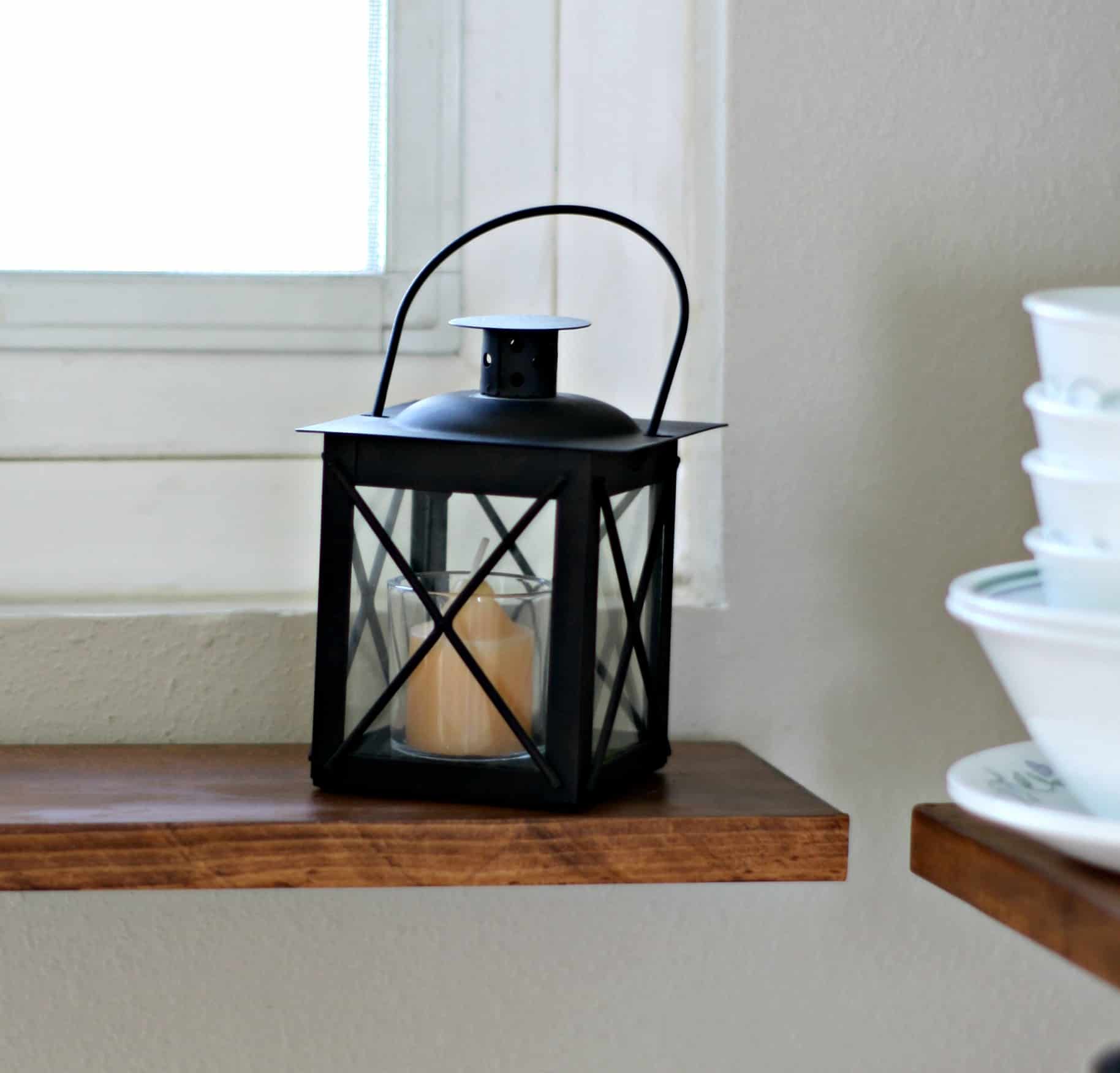 adding fall decor to a small kitchen black lantern on wood surface