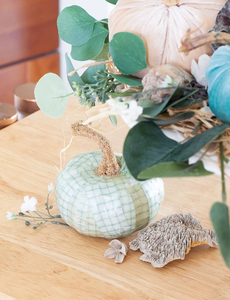 diy velvet pumpkins just like the pros decoupage pumpkin in aqua with leaves flowers and natural elements on top of a wood surface