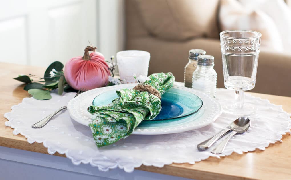 7 elements for a single fall tablescape table for one #2 table place setting with plates silverware glass salt and pepper shaker and centerpiece on a wood counter