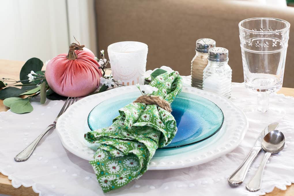 7 elements for a single fall tablescape table for one #2 table place setting with plates silverware glass salt and pepper shaker and centerpiece on a wood counter