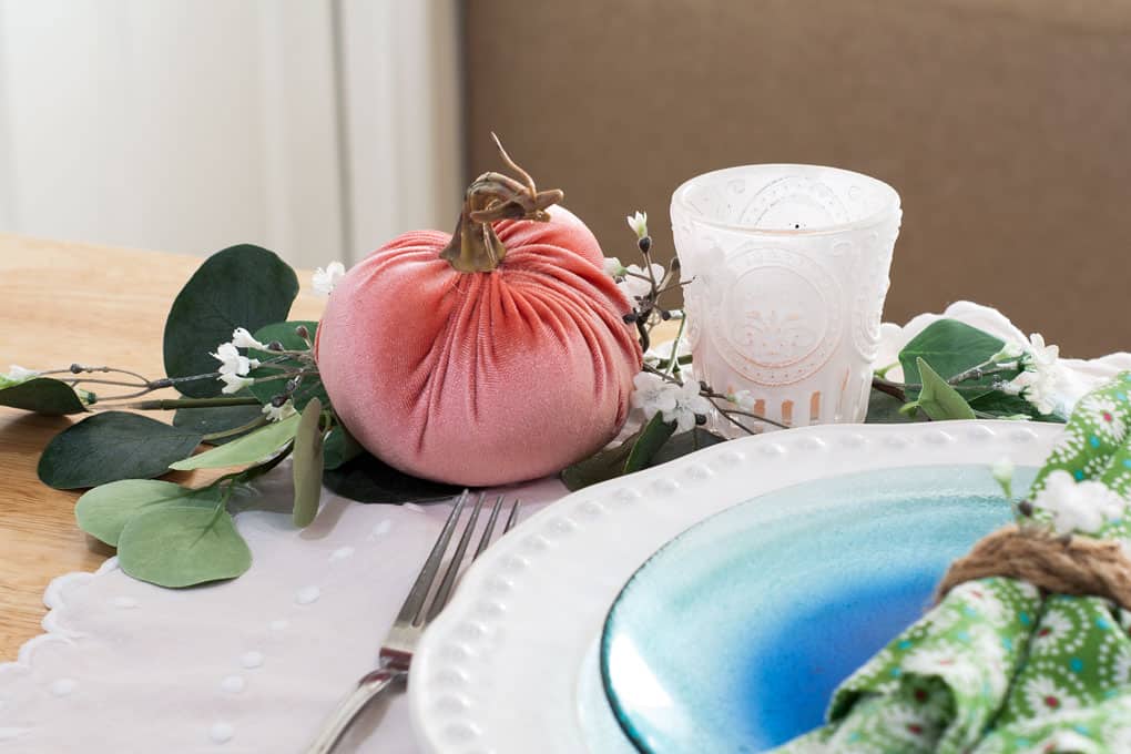 7 elements for a single fall tablescape table for one #2 table place setting with plates silverware pumpkin candle and foliage on a wood counter