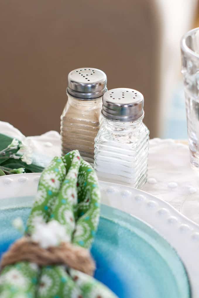 7 elements for a single fall tablescape table for one #2 table place setting with plates silverware glass salt and pepper shaker and centerpiece on a wood counter