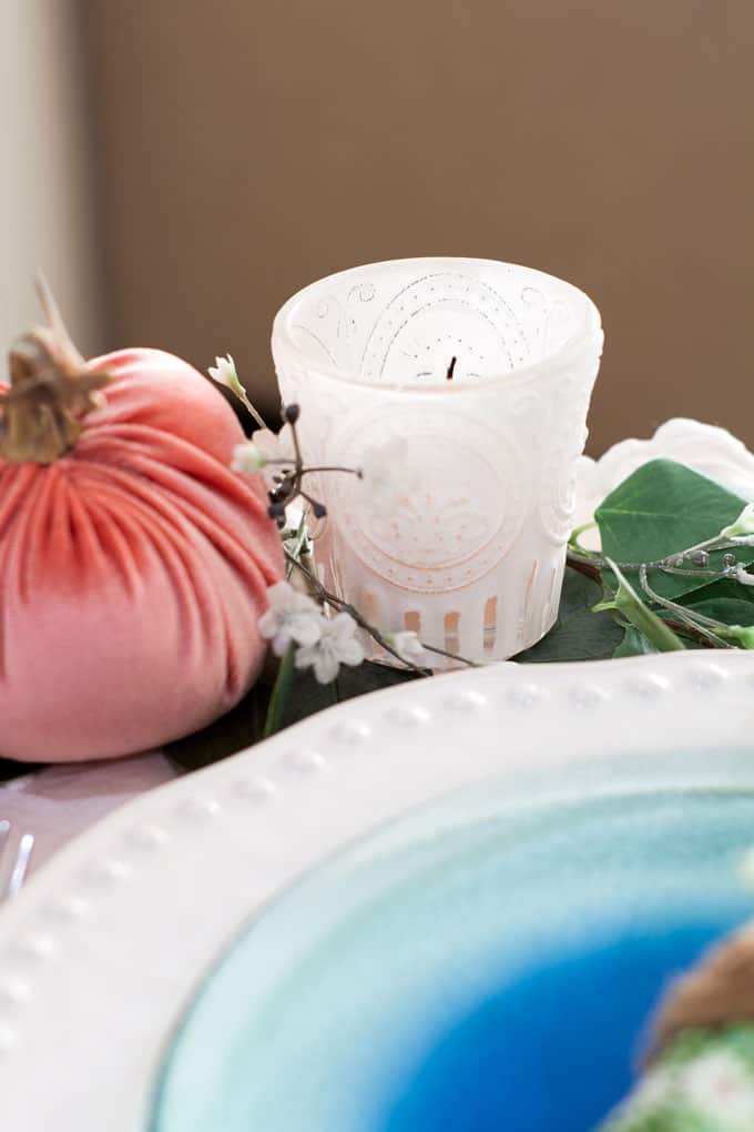 7 elements for a single fall tablescape table for one #2 table place setting with plates silverware pumpkin candle and foliage on a wood counter