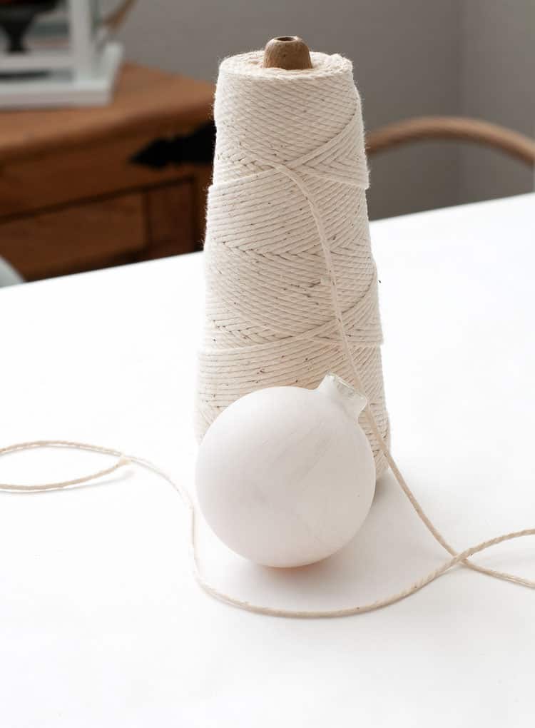 easy diy coastal christmas ornaments cotton twine and glass ornament on white table