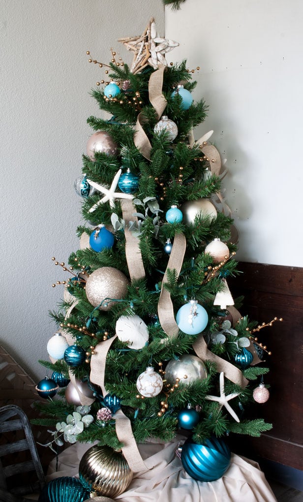 big ideas for decorating a small christmas tree with coastal ornaments and ribbon
