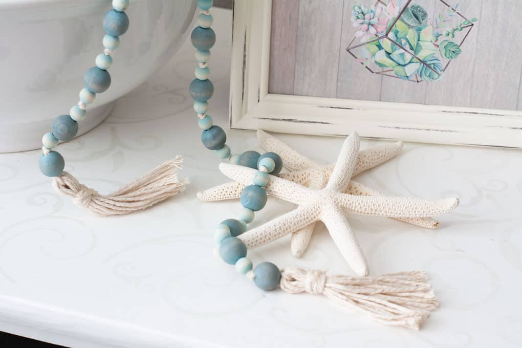 best of my wee abode 2018 wooden bead garland on white surface with star fish and frame