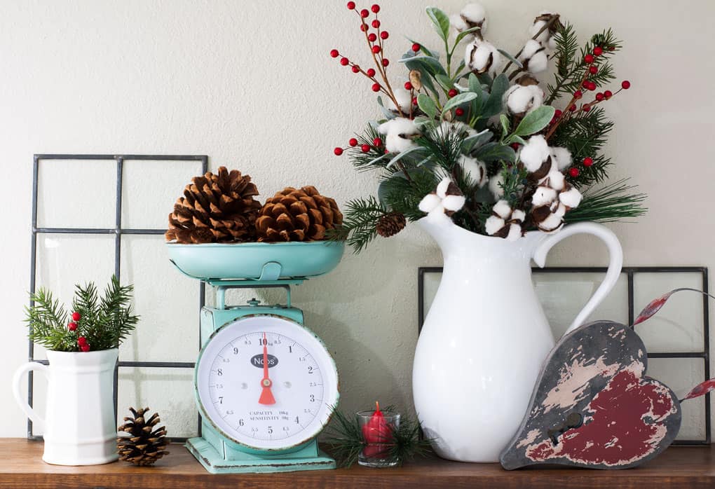 winter-valentine-decor-small-kitchen open shelving with scale white pitchers pine cones and greenery