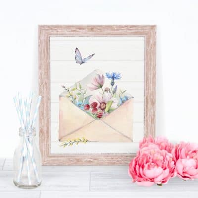 free spring watercolor wall art watering can with spring flowers on surface with pink flowers and straws in a bottle