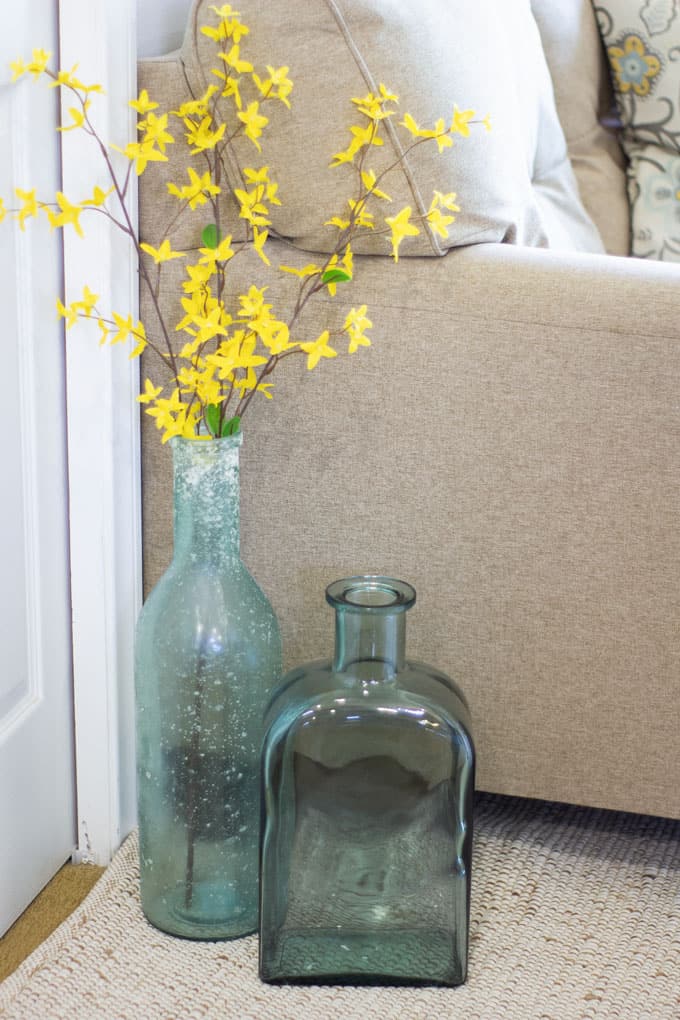 small home fall tour demijohns with faux flowers sitting on floor