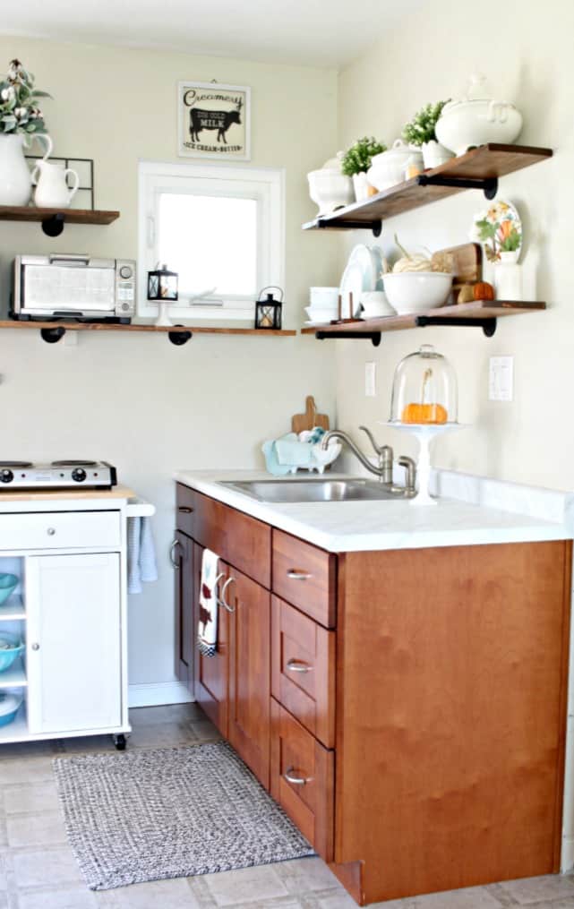 love your dark kitchen cabinets with white island and open shelving