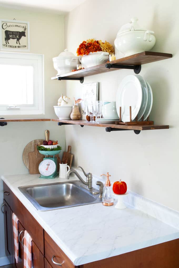 love your dark kitchen cabinets with open shelving and fall decor