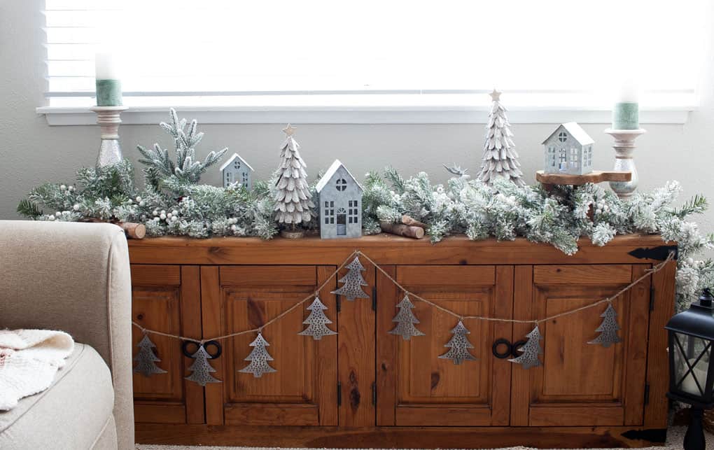window bench with flocked garland and Christmas decor elements in living room