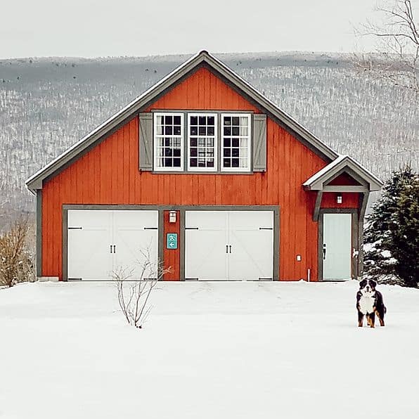 Vermont barn in snow with dog