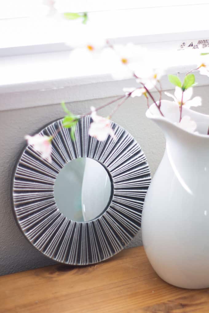 refresh your mantel with spring decor white pitcher with pink blossoms and mirror on window bench