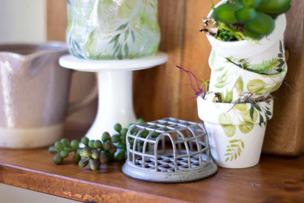 fresh spring vignette with flower frog and mini pots with succulent
