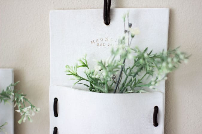 folded wall pocket with greenery on wall with Magnolia Market brand