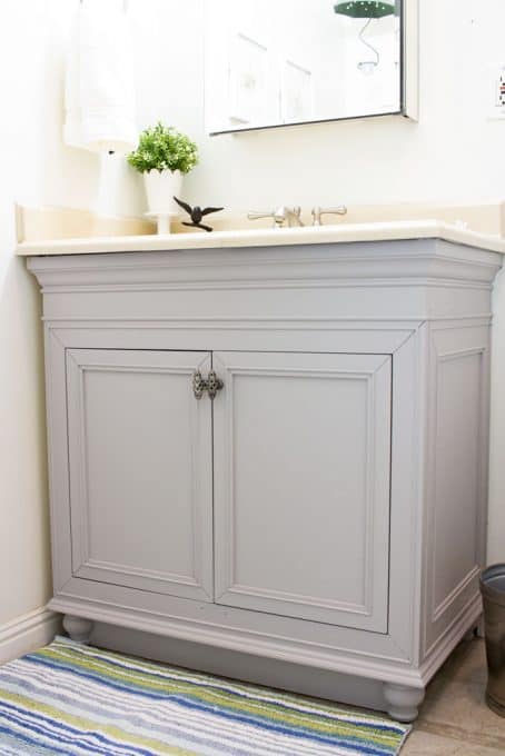 diy painted bathroom cabinets in gray with cream countertop