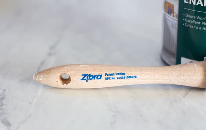 zibra paint brush handle on marble surface
