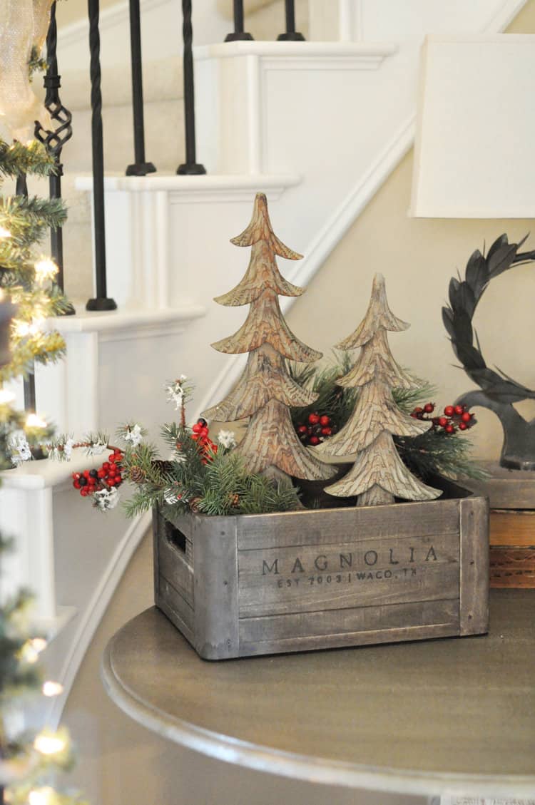 entryway christmas crate with trees greenery and berries
