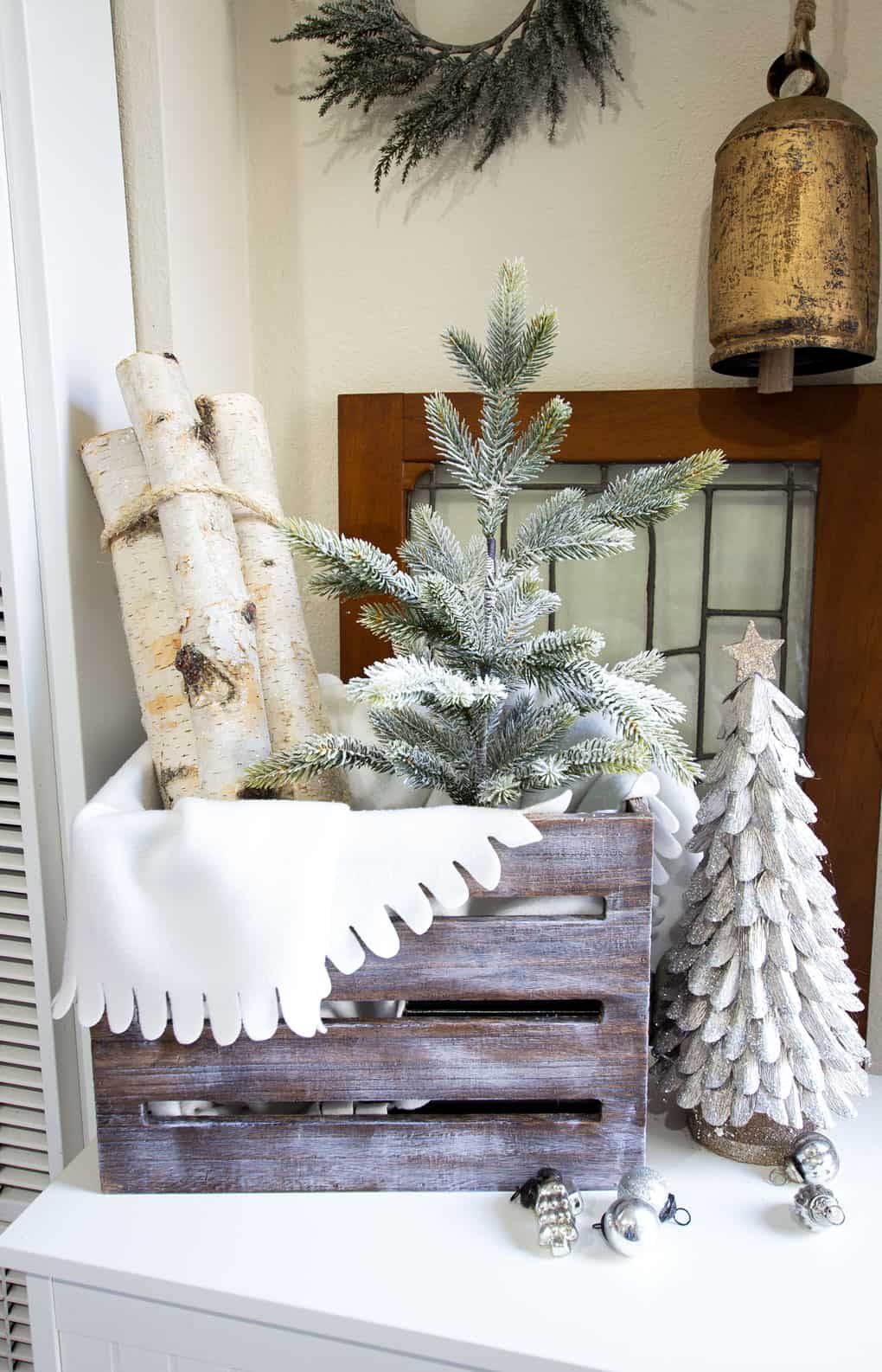 entryway christmas crate with tree and birch logs