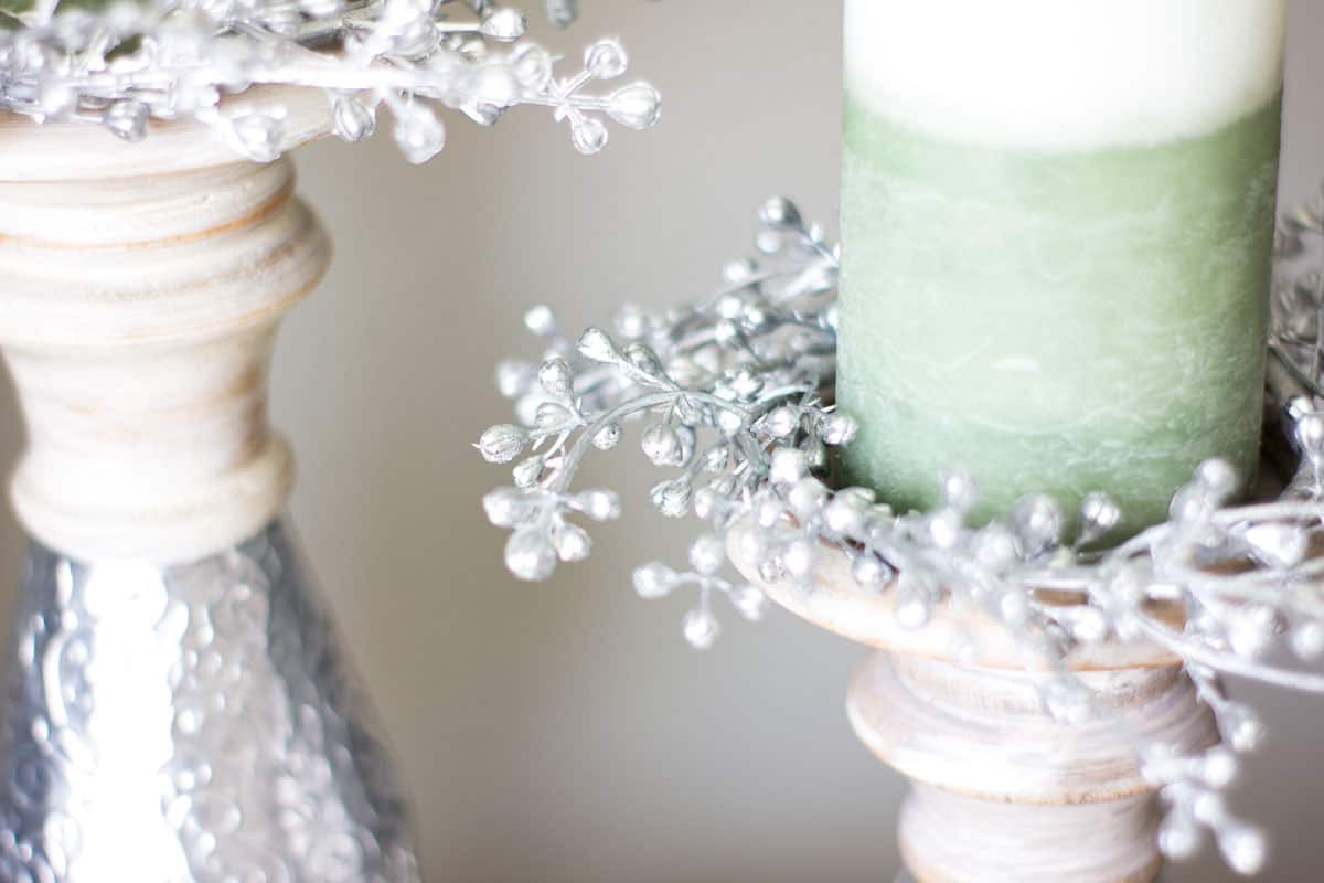 silver seeded candle ring on pillar holder with white green candle