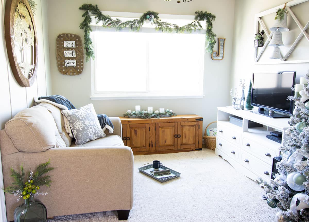 frosty christmas tiny home tour living area with christmas tree in mint and white and minty decor