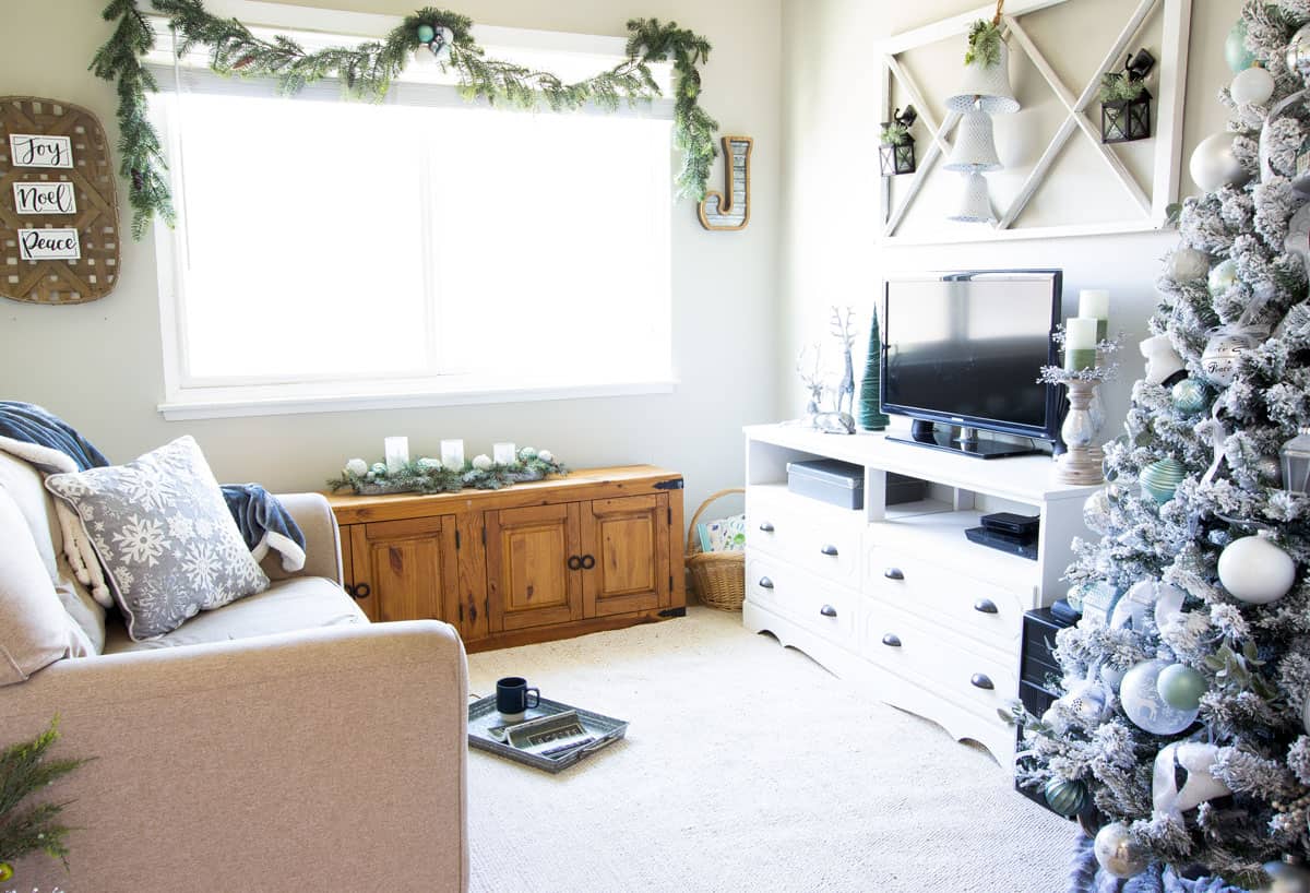 frosty christmas tiny home tour living area with christmas tree in mint and white and minty decor