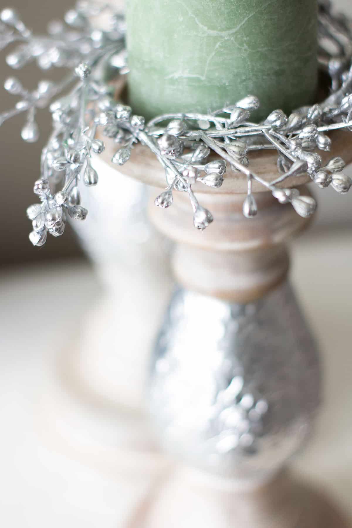 candle holders with green and white candle and sparkly candle rings
