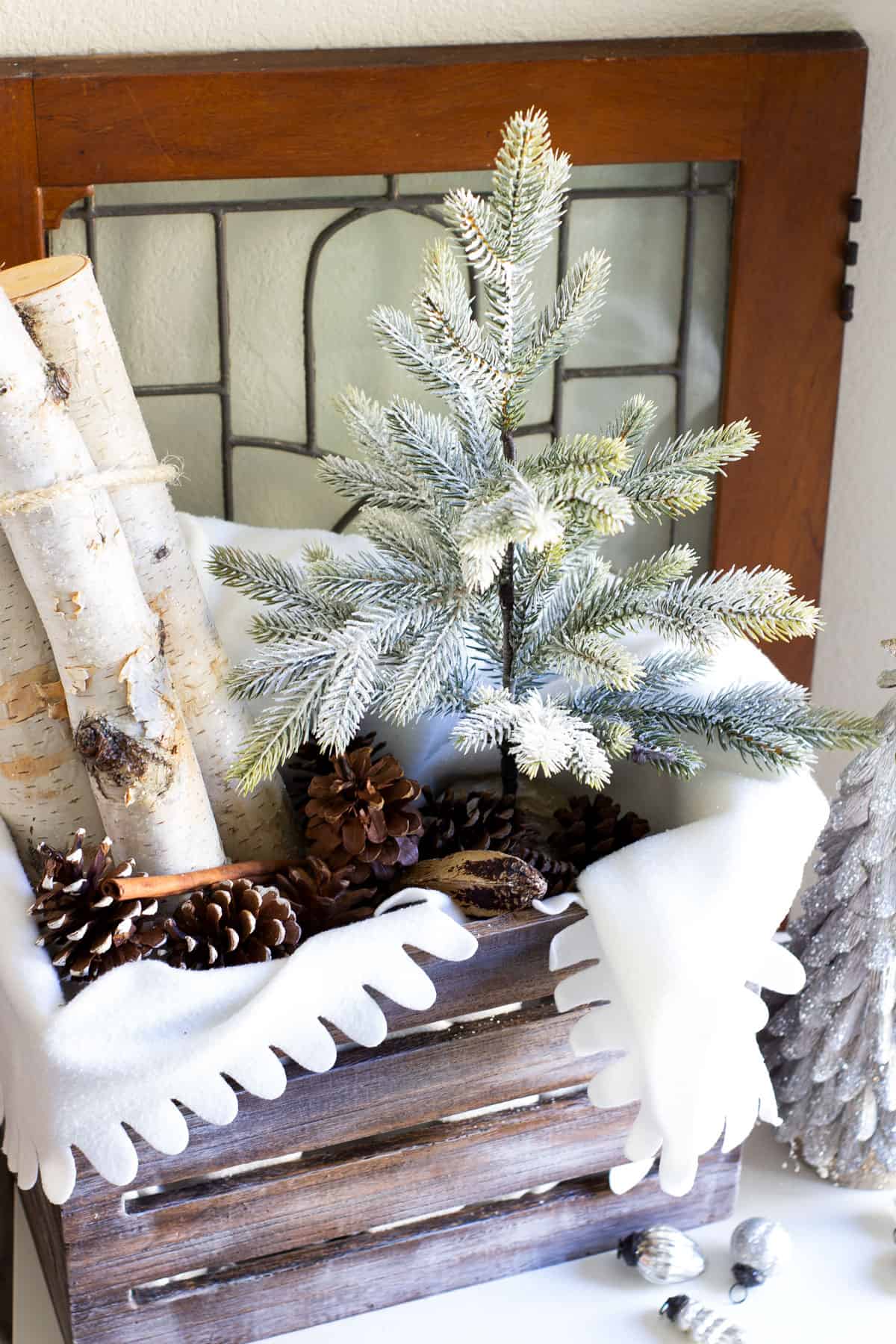 christmas crate with tree birch logs and pinecones