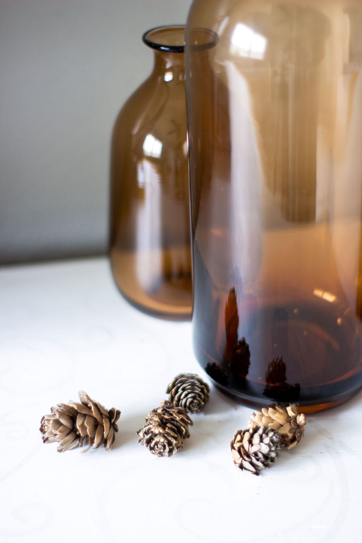 amber bottles with mini pine cones
