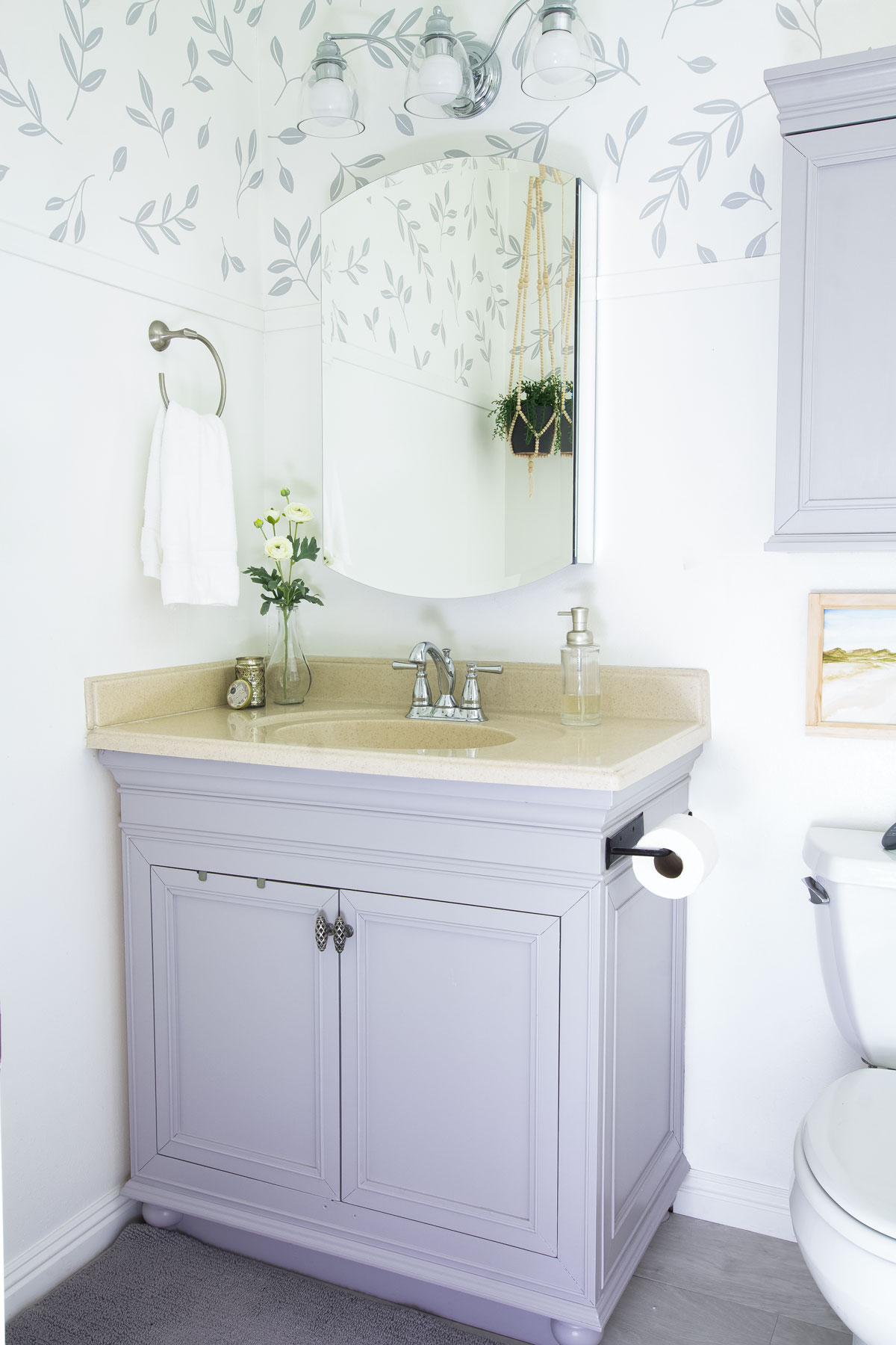 modern coastal bathroom makeover reveal bathroom gray vanity with leaf wallpaper and modern coastal elements