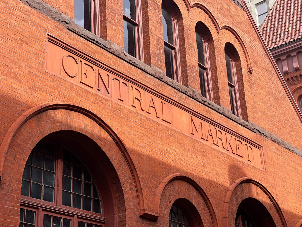 central market sign carved into brick building