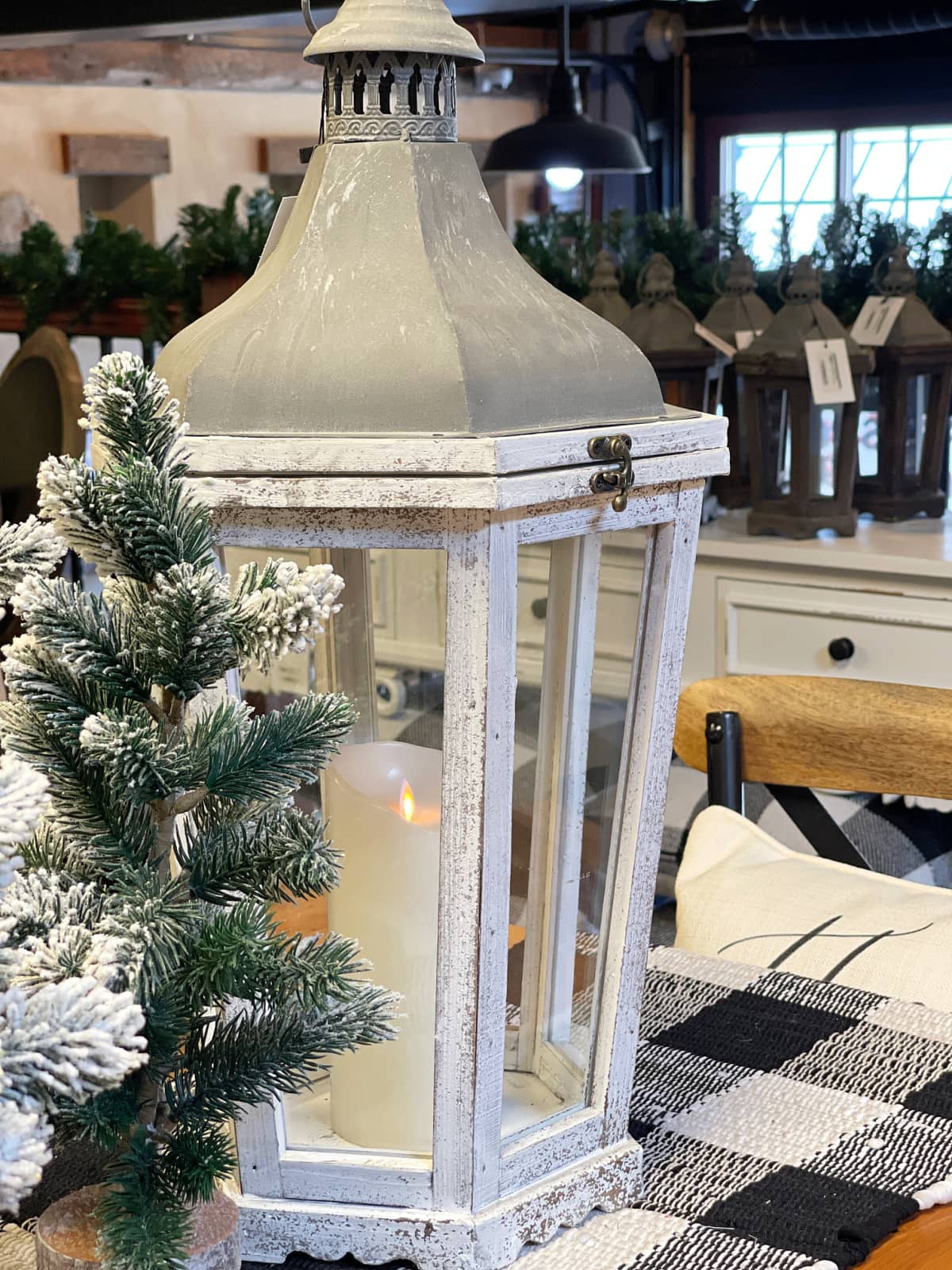 visiting lancaster county in the fall lantern with pine tree and candle on table