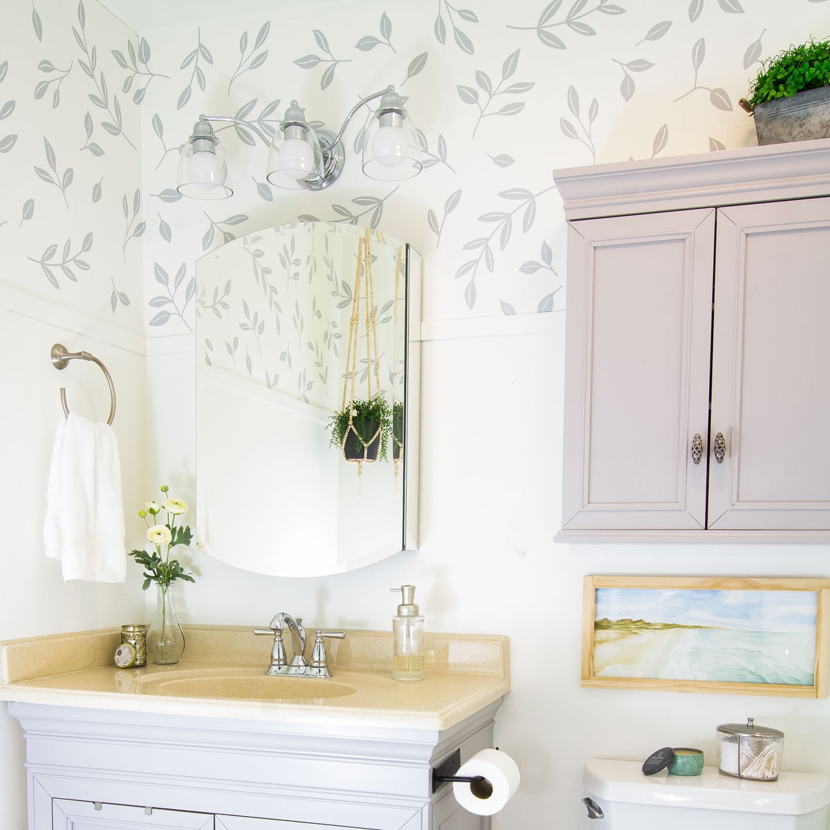 how to use vinyl decals for a wallpaper look bathroom wall with frog tape and vinyl decal leaves in bathroom