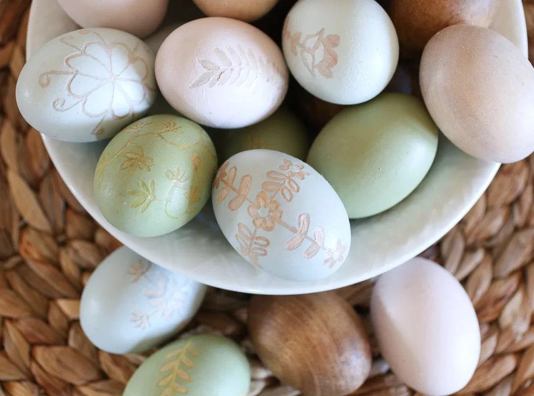 wooden easter eggs in a white bowl