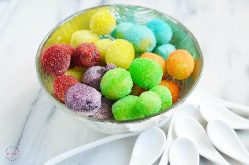 rainbow grape treats in a white bowl with white spoons