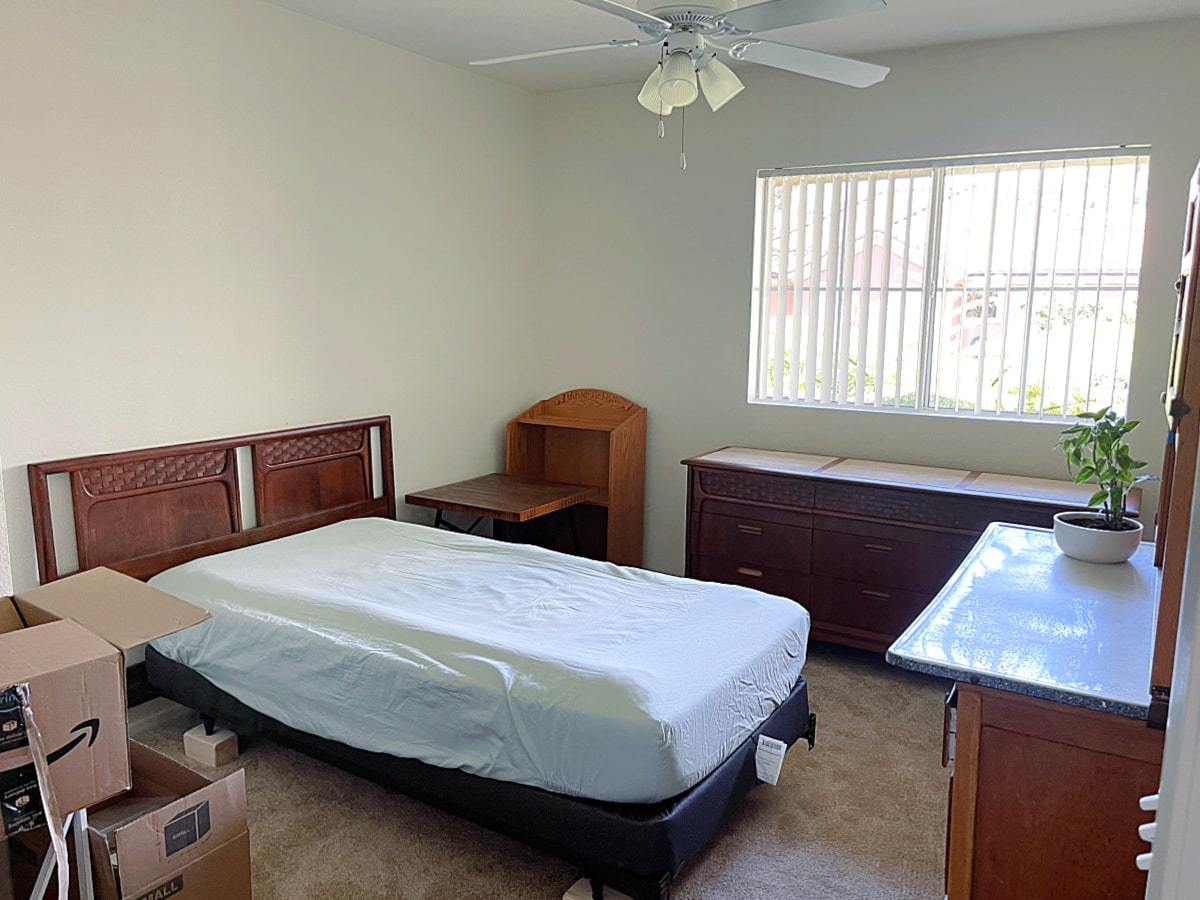 bedroom in moving-in state with bed and furniture