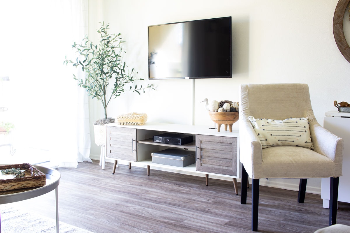 tiny summer home tour living area with tv console olive tree and chair
