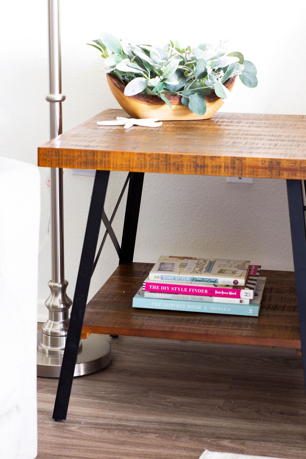 tiny summer home tour side table with books and floral arrangement
