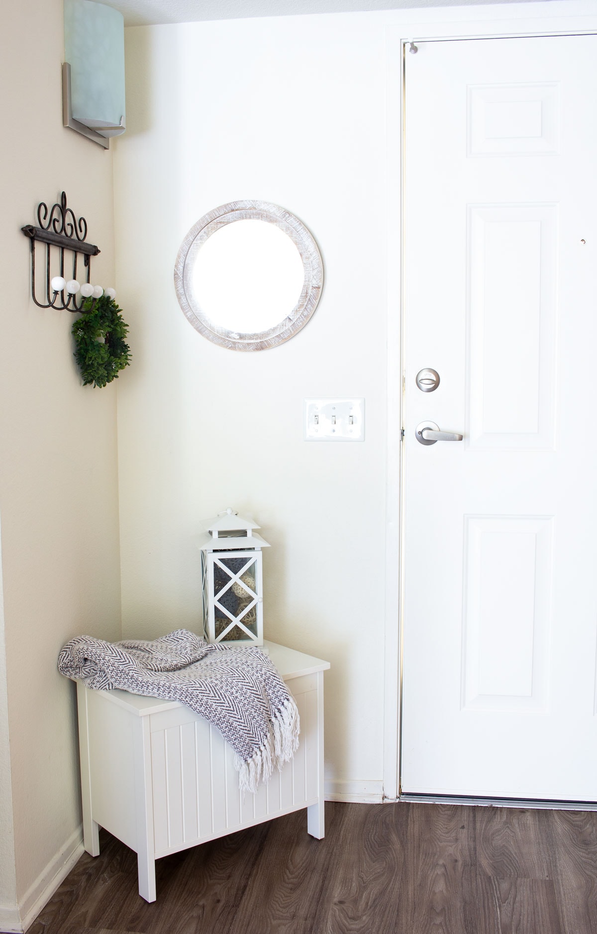 tiny entryway with bench mirror coat hanger lantern and blanket