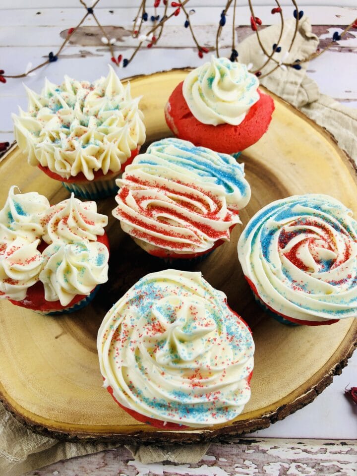 red white and blue cupcakes on plate with different designs