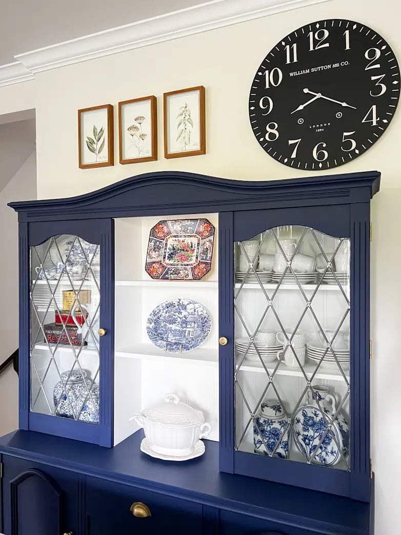 tuesday turn about 158 july diys blue china cabient with decor and clock on wall