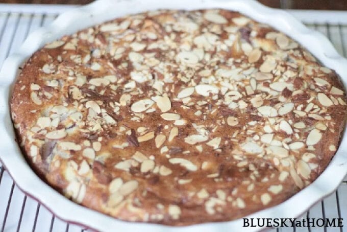 cake dessert with nuts on top in white dish