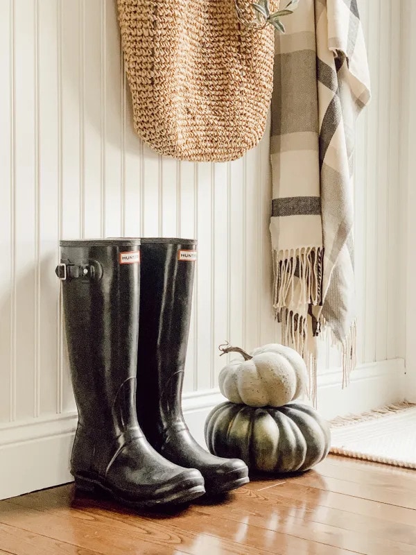 tuesday turn about 166 give me pumpkins on floor with rubber boots and coat hanger with tote and blanket